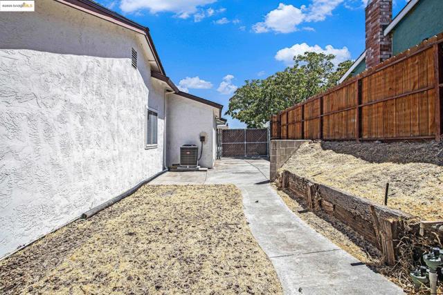 View of side of home with a patio area and stucco siding