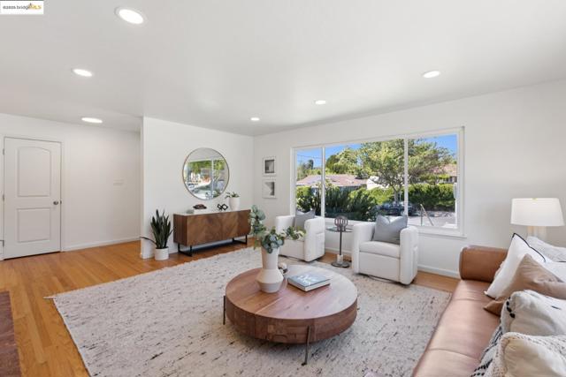 Living area with light wood-style flooring and recessed lighting