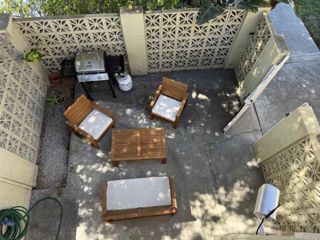 view of private patio from balcony