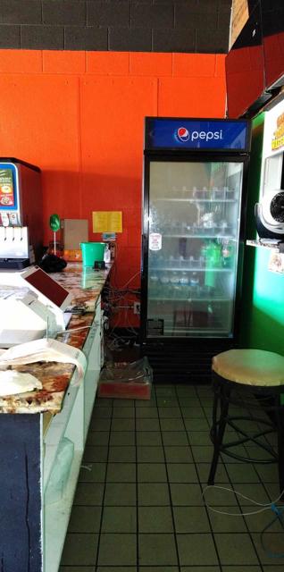 TACO SHOP BEHIND CASHIER PEPSI FRIDGE