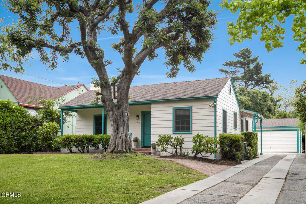 Resting on a picturesque, tree-lined street in Pasadena's enchanting Bungalow Heaven Historic Landmark neighborhood, 1268 N Holliston Ave is a classic 1930s gem brimming with potential! Available for the first time in 90 years and perfectly preserved, this home sits on a flat, usable lot of nearly 11,000 sqft and offers the perfect canvas to create your dream home! Set back far from the street, there's plenty of room to run and play on the grassy front lawn shaded by a mature Elm tree. On summer evenings as the sun begins to set, you'll enjoy a nice glass of wine on the front porch, waving to your friendly neighbors as they stroll by. Stepping inside, find original hardwood floors and bright, welcoming living spaces starting with the living room. To the right, sunlight pours in through paned windows in the dining room and a spacious kitchen sits nearby.  Offering a seamless flow for daily living and entertaining, the home's thoughtfully designed layout places the sleeping quarters towards the rear to provide a tranquil retreat. Outside, the grassy backyard includes a mandarin tree and abundant space for play, hosting lively gatherings, and creating a lush secret garden. With McDonald Park nearby and the delightful shops and cafes on Washington Blvd around the corner, you'll love Saturday morning walks around the neighborhood. Full of charm both inside and out, you're sure to savor life in this beautiful home nestled in one of Pasadena's most vibrant and tight-knit communities!