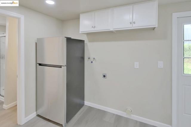 Laundry area with electric dryer hookup, washer hookup, and recessed lighting