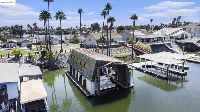 Dock featuring a residential view, a water view, and boat lift