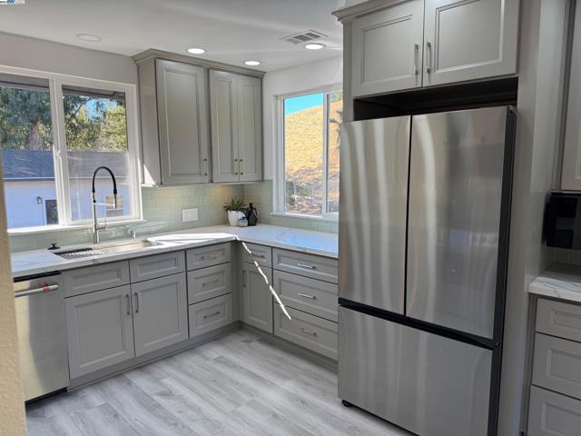 Kitchen includes Samsung side by side stainless Fridge