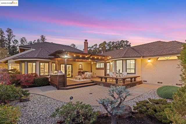 Back of house featuring crawl space, a patio area, stucco siding, and a chimney