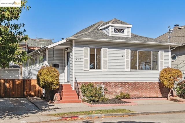 Bungalow-style house with roof with shingles and brick siding. Photo has been altered / edited.