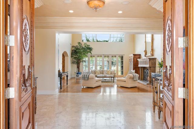 Through the massive hand carved entry doors into the inviting living room