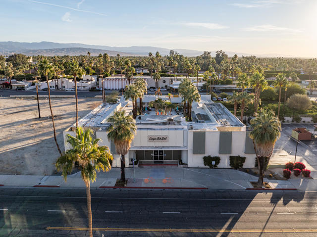 Presenting a rare opportunity to own a piece of Palm Springs history: one of its most iconic hotel properties, ideally situated on bustling Palm Canyon Drive in the heart of downtown. Nestled amongst vibrant restaurants, retail shops, and nightlife, this 1.19-acre property borders the prestigious Old Las Palmas and Movie Colony neighborhoods. Currently operating as a clothing-optional men's resort, the property is zoned R-3 Multi-Family Residential and Hotel, offering diverse possibilities for future development. Built in 1951 as the La Fonda Hotel, the property features 32 guest rooms ranging from 300-400 square feet, eight of which include full kitchens. All rooms offer picturesque views of either the surrounding mountains or the expansive pool area. Amenities include a welcoming lobby, business center, large resort-style pool and spa, on-site laundry, playroom, steam room, and sauna. A significant undeveloped portion of land (approximately 9,000 sq ft) at the southeast corner presents exciting potential for expansion or new construction. While the location is undeniably prime and the original architecture is iconic, the property is in need of updating. Buyers are advised to conduct their own due diligence.