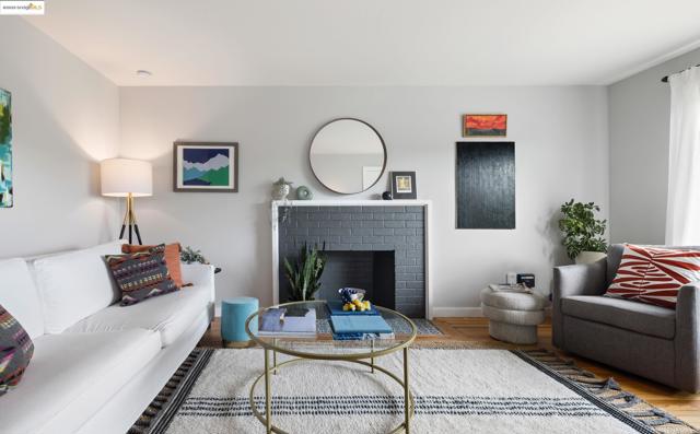 Living area with a fireplace and wood finished floors