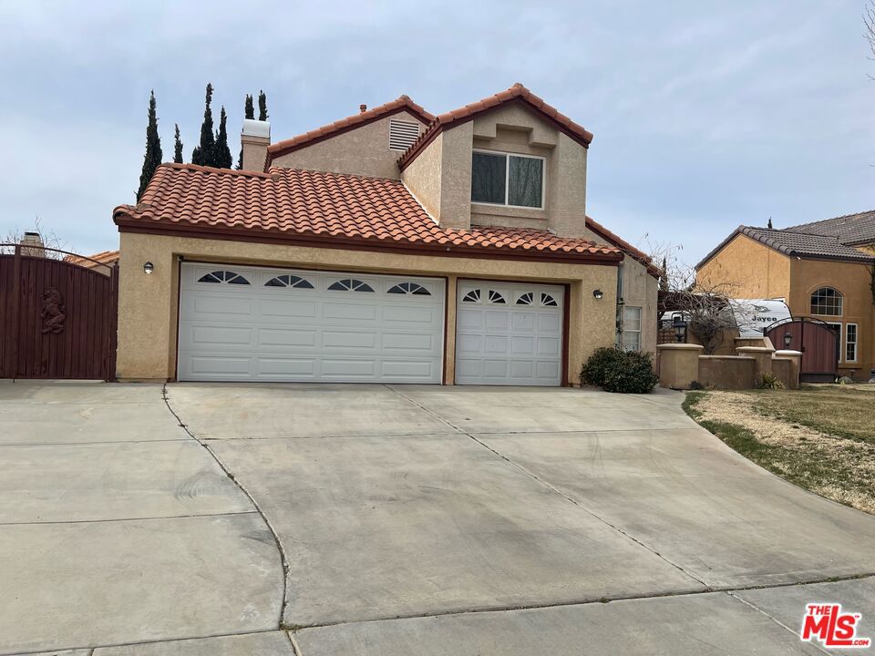 This home is in an established neighborhood on tree lined street near the Palmdale Water Park. This large 2 story home features a 4 bedroom and 2 1/2 bathrooms, with an attached 3 car garage. The interior of the home is open and spacious. The family room has a cozy feel with a fireplace. The living room is adjacent to the dining room, which welcomes you in from the front entry. All of the bedrooms are spacious and the master is over sized with a large master bathroom. Plenty of space in the rear yard with covered patio for summer bbq's and entertainment. The house is close to shopping, entertainment, a short trip to Pear blossom highway and the 14 Freeway. Don't miss the opportunity to make this your home!
