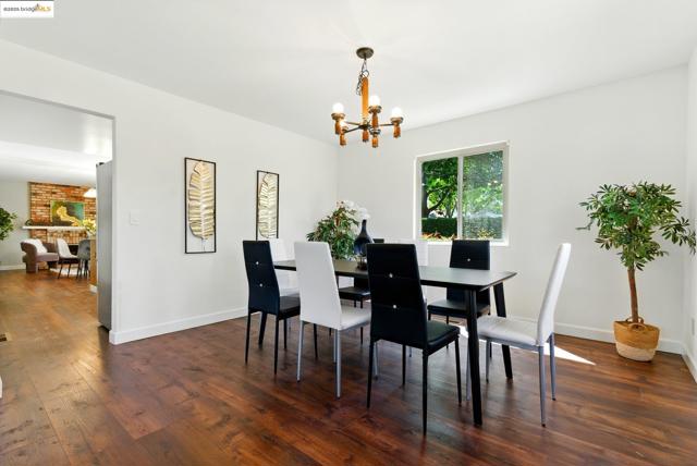 Dining area featuring a chandelier and dark wood-style floors