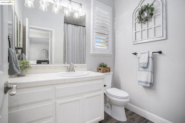Bathroom located next to bedroom 4 with vanity, step-in shower, and shutters.