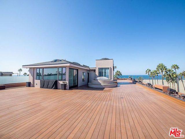 8 Brooks Avenue Penthouse Venice, California Premier beach front Penthouse offering the largest wrap-around deck on the Santa Monica Bay. The sleek 1,800 square foot 2 bedroom 3 bathroom Townhouse apartment with vaulted ceilings, hardwood flooring, fireplace, reverse osmosis drinking filter, whole-house water filtration system, and marble countertops with high end appliances provides seamless indoor-outdoor living with 2 sets of Nana Walls in the living room. Both bathrooms provide marble counters and floors, one offers a double sink vanity, both have built in bidet toilets. There is an outdoor barbecue with refrigerator.