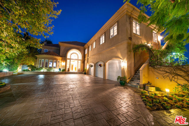 2270 Worthing Lane Los Angeles, California Exceptional Villa in the exclusive and gated Bel Air Crest. This private and secluded Villa sits on a hill at the end of a cul-de-sac, with unobstructed panoramic views. Enter through a chandeliered majestic foyer that sends you into a sumptuous formal living room with space for a piano, complemented with a formal dining room of generous size that calls for great entertaining. This Lower Level also includes a family room with plenty of space and a media room. The majestic staircase at the foyer will bring you to the Upper Level with a 1,200+/-sqft Master Suite with two separate lush bathrooms, two large dressing rooms/walk-in closets, a sitting room, a Swedish sauna, a balcony with magnificent views, and a romantic fireplace. The same Upper Level has three more bedrooms en suite to accommodate everybody. Back in the Lower Level, there is a fifth bedroom en suite for guests or the maid, a 500+ bottles wine cellar that complements a kitchen with everything you dream for: 60 Wolf range, four ovens, commercial Subzero refrigerator, a built-in Miele espresso machine, luxe granite countertops, two dishwashers, 3-motor exhaust hood, and tons of custom cabinetry, making it a dream master chefs kitchen. The large lot surrounds the Villa, creating different garden terraces with lush vegetation and a breathtaking pool to splash in while soaking the spectacular surrounding views. There will never be a shortage of space or panoramic views in this exceptional Villa!
