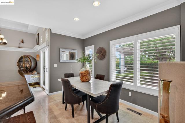 Dining room featuring crown molding, light tile patterned floors, plenty of natural light, and recessed lighting