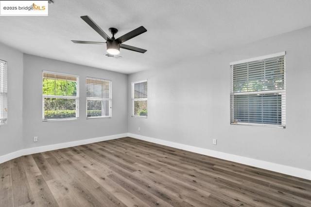 Spare room featuring wood finished floors and ceiling fan