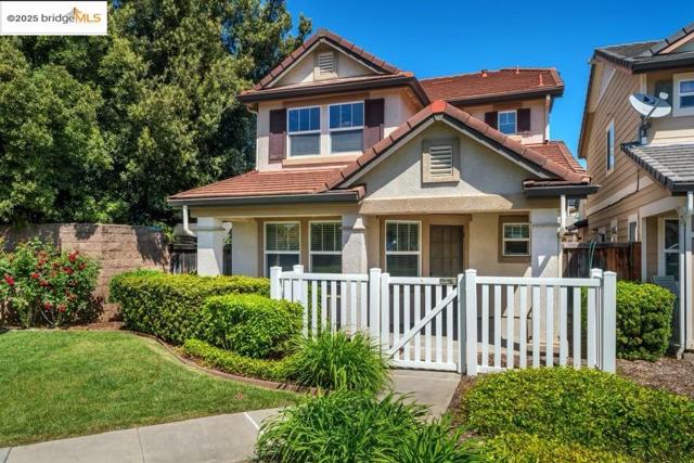 View of front of home with stucco siding and a tiled roof