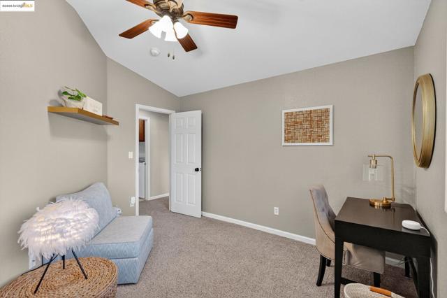 Bedroom with vaulted ceiling and a ceiling fan