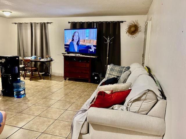 Livingroom, dining area, and kitchen with tile floors.