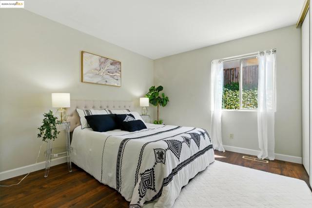 Bedroom with baseboards and wood finished floors