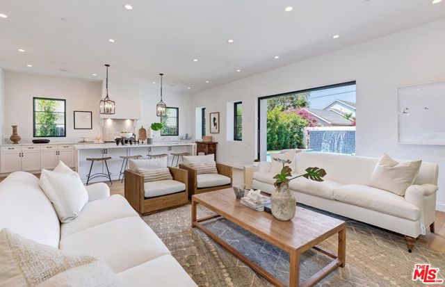 2326 Louella Avenue Venice, California Crafted as a modern residence with Spanish influence, this striking property blends seamlessly into its surrounding tree-lined Venice neighborhood. A hand-applied stucco exterior and vibrant tiled roof produce a traditional LA home, while vibrant plantings, wrought iron details, and tile accents elevate the home's facade. Spanning approximately 3,436 square feet, the home's interior features stunning wide-plank hardwood floors, delicately applied plaster walls, exposed wooden beams, and intricate designer details. A soaring entry foyer ultimately unfolds into the formal dining room, oversized family room, and gourmet kitchen, fashioned with timeless custom white cabinetry, hardy stone countertops, a top of the line appliance , and distinct designer accents. Sliding glass doors flood the home with natural light, while also offering an indoor/outdoor flow to the generous property, outfitted with a waterfall pool and spa. Upstairs, the primary suite is completed with a walk-in closet and a spa grade bathroom, designed with a freestanding tub, walk-in shower, beautiful tiled details, and the finest of fixtures. Three secondary bedrooms are laid out alongside the primary suite, one as an ensuite, and two sharing a Jack & Jill bathroom. Rounding out this exceptional residence is a first-floor ensuite secondary bedroom, first-floor powder room, second-floor laundry room, two car garage, smart home technology suite, and high grade heating and cooling systems.