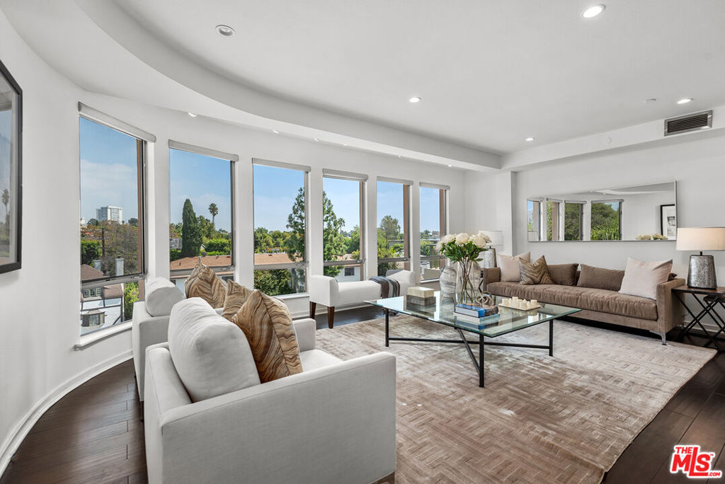 Sleek, contemporary, townhouse style condominium in boutique 12 unit building, built in 2001. 2 beds, 2.5 baths in over 2,000 square ft in this exclusive penthouse unit.  The living room has huge curved glass windows, wood floors, fireplace and a balcony.  This romantic balcony looks out to stunning Century City views at night. Cook's kitchen with stainless appliances.  Second bedroom also has a balcony.  Primary suite is down a stylish curved staircase. This unit faces east, avoiding the hot afternoon sun.  Separate tricked out laundry room in unit, with side by side washer and dryer.  There are two side by side parking spaces, plus guest parking in the garage below the building.  The monthly HOA fees include earthquake insurance.  This spectacular home was owned by the Rapper and Actor, Ludacris, from 2007 to 2013.
