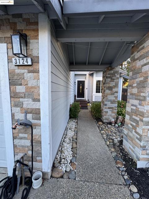 View of exterior entry featuring stone siding