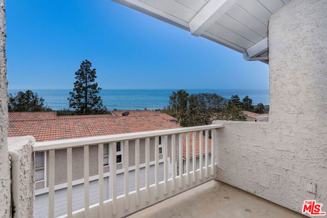 Desirable top row townhome with stunning ocean views! Upon entering is the sun-filled living and dining room with soaring ceilings, oversized windows to enjoy the ocean view, and custom hardwood floors. Open kitchen comprises of large panty room, farmhouse sink, and Thermador cooktop and double ovens. The spacious primary suite features private balcony, oversized closet, double vanity sinks, and free-standing soaking bathtub. Upstairs is the loft suite with hillside views and private bathroom. The lower level 2nd bedroom includes en-suite bathroom and private garden patio. Attached two car garage with laundry and storage room. Community amenities include guard, pool/spa, guest parking, clubhouse, and sun deck. Easy access to world-renowned Paradise Cove Beach across the street.