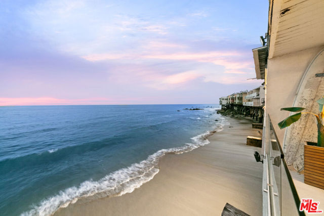 Beautiful Las Flores townhome on the sand. Open floor plan, fireplace, remodeled bath with glass tile, inside laundry and oceanfront deck. Two bedrooms upstairs including primary bedroom and bath with spa tub and oceanfront deck. Steps to the beach from the courtyard, close to Malibu town or Santa Monica. Fee simple land.