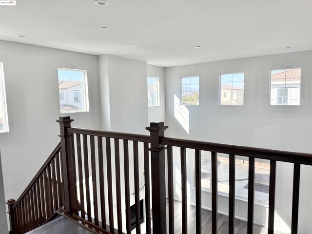 Stairs featuring wood finished floors and recessed lighting