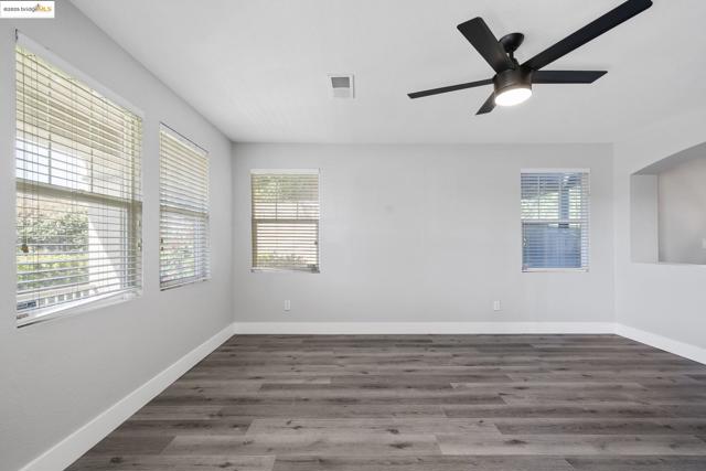 Unfurnished room featuring wood finished floors and ceiling fan