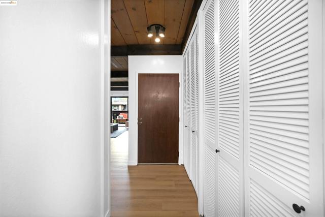 Corridor featuring wood finished floors and wood ceiling