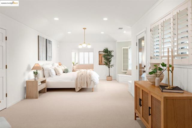 Bedroom with crown molding, light colored carpet, and recessed lighting