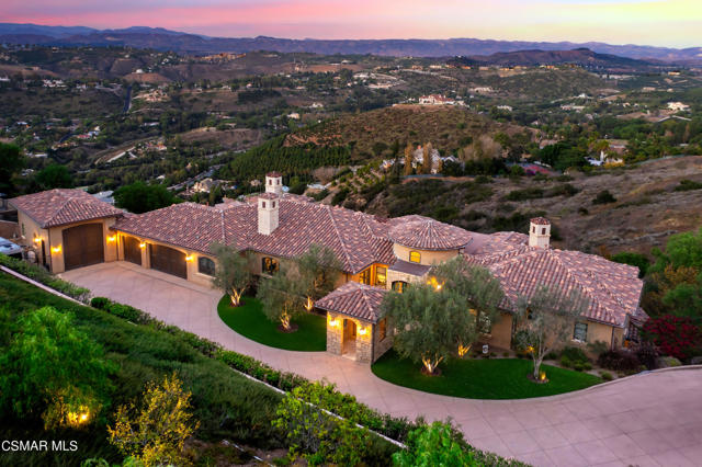 Perched atop a serene hill in Thousand Oaks, California, this captivating custom-built Mediterranean estate boasts approximately 7,374 square feet of living space on a sprawling 6.82-acre property. This private sanctuary offers an unmatched sense of seclusion and awe-inspiring views overlooking the Santa Rosa Valley, with vistas extending toward the iconic Ronald Reagan Library.As you enter through the gated entrance, a secluded motor courtyard welcomes you, setting the tone for the exclusivity and privacy that define this property. The custom touches throughout the home include floor-to-ceiling stonework with distressed beams, Walker Zanger tiles, and wide plank hardwood flooring. These exquisite details add character and charm to every corner.The primary suite, a true retreat, is conveniently located on the main level, offering easy access and a serene escape. Views from almost every room in the house, especially those looking to the northeast, capture the breathtaking scenery that surrounds the property.This expansive home features five en-suite bedrooms and a total of seven bathrooms, ensuring that each resident and guest enjoys the utmost comfort and privacy.The heart of this residence is a kitchen open to the family room. It includes a granite center island with matching copper hand-hammered sinks, perfect for culinary gatherings. The kitchen also boasts a Viking oven, complete with a 6-burner stove with a griddle, a steam oven, a walk-in pantry, and a butler's pantry. Whether you're an amateur cook or a seasoned chef, this kitchen is a culinary masterpiece.Step outside, and you'll find that this home is an entertainer's dream, featuring an infinity pool and spa with a swim-up bar, cascading waterfalls, and an exhilarating waterslide. The outdoor BBQ/ kitchen provides an ideal setting for alfresco dining and entertaining, allowing you to host gatherings in a picturesque setting.The property offers a five-car garage, a haven for car enthusiasts, an RV garage/workshop, and plenty of parking space for guests on its expansive grounds.Inside, you'll discover a lower floor party room, leading to the dream home theatre. This is the ultimate space for entertaining and enjoying movie nights in a setting of pure luxury.For added convenience and accessibility, the home has a designated space designed for a future elevator, making it accessible to all.Outside, you'll find low-maintenance landscaping, allowing you to enjoy the beauty of the property without the burden of extensive upkeep.This Thousand Oaks estate represents a rare blend of impeccable design, breathtaking views, and luxurious amenities. Whether you seek a peaceful retreat, an entertainer's paradise, or a family haven, this property fulfills every desire.Don't miss the chance to own this slice of California paradise. Contact us today to arrange a private showing and experience the magic of this extraordinary Mediterranean estate firsthand.