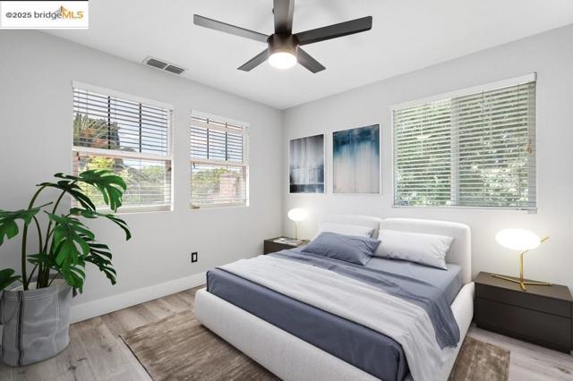 Bedroom with wood finished floors and a ceiling fan