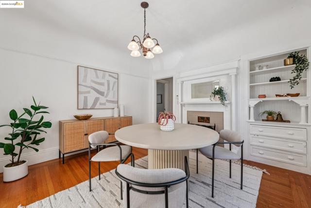 Dining room featuring a fireplace, wood finished floors, and a chandelier