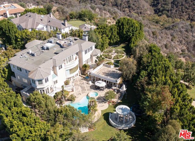 2243 Weybridge Lane Los Angeles, California Located in the prestigious Guard Gated Community of Bel Air Crest. This rare trophy property offers privacy and canyon views out to the ocean. An extraordinary double lot with one of the largest backyards in any A+ gated community outside of Beverly Park. This developers dream property is the epitome of value-add or reposition and keep the current tenant who is outside of their lease. Situated on almost 12,000 S/F of livable space the property sits on over a full acre of land. Enjoy an inspired waterfall and bridge that lead to gardens and a beautiful pool, a large pool house and gazebo.This custom-built home with (7) bedroom suites and a primary bedroom with two baths and walk in closets is wonderfully though out. The property has a stunning floorplan that opens up to a double staircase with spacious rooms and expansive glass windows, theater, game rooms, elevator, gourmet kitchen with flowing staircases. The front of the property is set back behind gates featuring a generous motor court and garage that accommodates (6) cars. Community has tennis courts, gym, club house, playground and putting green. This unique opportunity to 1031 exchange with a strong existing cashflow or develop is impressive and unusual. Photos are no longer current but represent the property as it was originally presented. Showings will be on Mondays, Wednesdays, and Fridays 1-5pm.