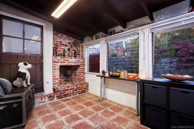 Bonus room with brick fireplace currently used for food storage/pantry.