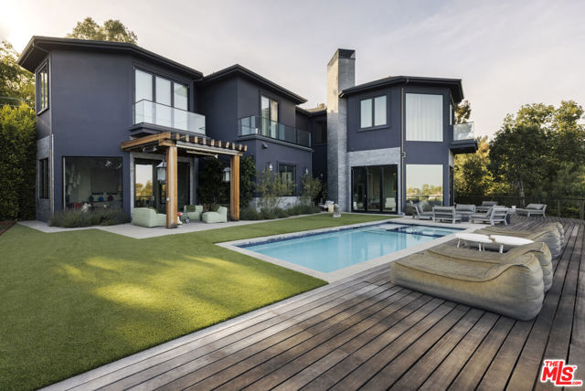 1774 WESTRIDGE Road Los Angeles, California Located 3 minutes from Sunset Blvd in prime Lower Mandeville Canyon sits this contemporary 6BR/5BA compound. Gated, hedged and completely private, the designer-done home features open and airy interiors with rich finishes and twelve-foot-plus ceilings throughout. The gourmet kitchen opens up to formal and informal living spaces, with tons of natural light and expansive city and canyon views. Upstairs, guests will find custom built-ins surrounding a library and 4 bedrooms all with en-suite baths. The primary suite is complete with explosive city/ocean/canyon views, fireplace, spacious bath with dual vanities, and huge walk-in closet. Additional features include a resort-style backyard with pool, spa, outdoor kitchen, firepit, water feature, bocce ball court and all-day-sunlight. The perfect home for Southern California living - Must be seen to be appreciated.