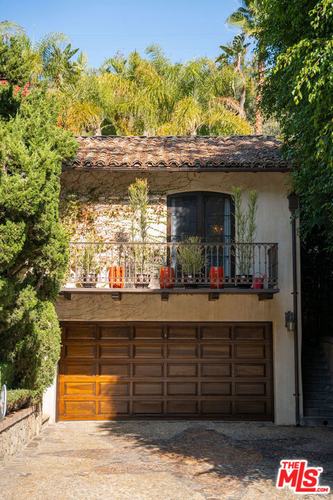 1642 N Beverly Drive Beverly Hills, California Beautifully remodeled, Spanish, BHPO estate featuring 4 spacious bedrooms, 3.5 baths, expansive interiors & private guest house. With sky-high, wood-beamed ceilings throughout, the 2,000 SF main house includes stone fireplaces, custom cabinetry and rich hardwood flooring, all surrounded by lush, mature landscaping. The residence features a large chef's kitchen with adjoining built-in bar/lounge, formal dining room, office/library and multiple outdoor patios, terraces & entertainment areas. Under exotic California greens, outdoors enjoy a dip in the sparkling jacuzzi or traverse through stone-pathed gardens to the 500 SF guest house, complete with private entrance, cascading waterfall feature, koi pond, built-in BBQ & dining area. An elevated, sunny oasis within the Warner Elementary School district, near both Franklin/Coldwater Canyon Park & access to Beverly Hills shopping & dining in just minutes.
