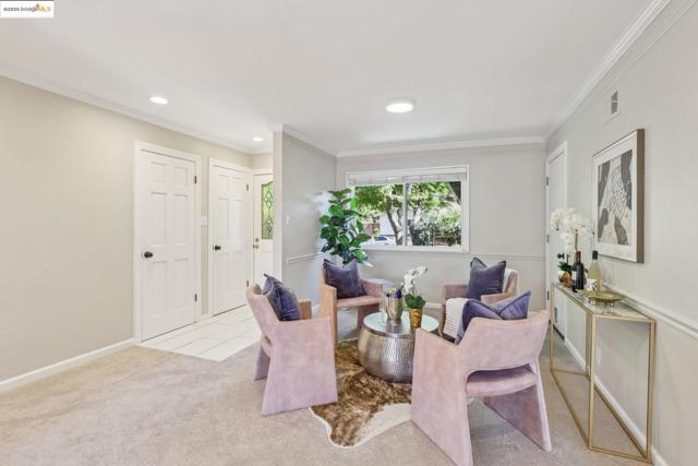 Living area featuring carpet floors, ornamental molding, recessed lighting, and tile patterned floors