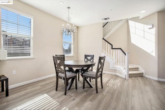Dining space featuring stairway, healthy amount of natural light, light wood-type flooring, and recessed lighting