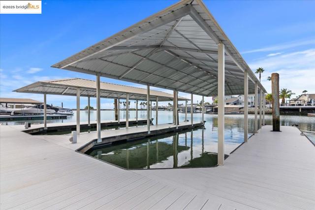Dock featuring boat lift and a water view