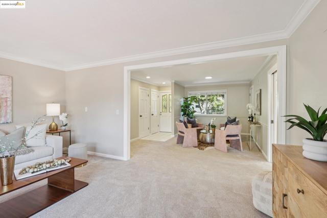 Carpeted living room featuring crown molding and recessed lighting