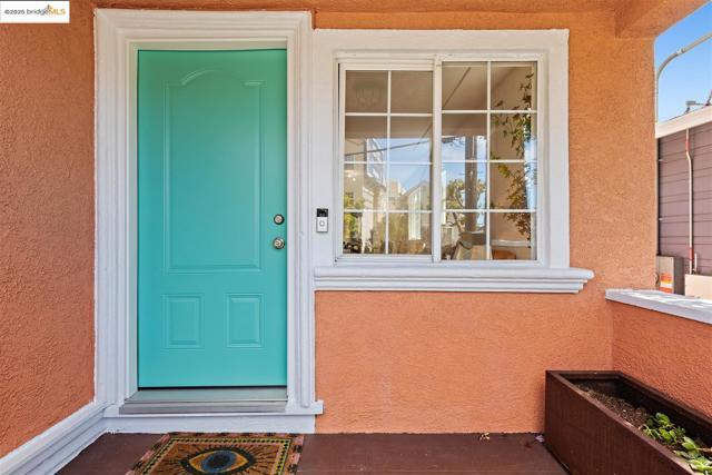 View of exterior entry with stucco siding