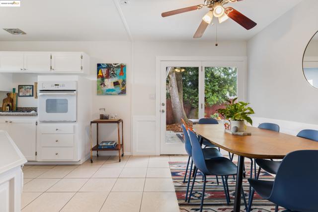 Dining area with light tile patterned floors and a ceiling fan