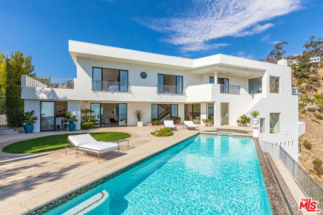 1924 Sunset Plaza Drive Los Angeles, California This stunning modern residence is just moments from the famed Sunset Strip and features unobstructed jetliner views from Downtown to the ocean. Set on a separate private drive off Sunset Plaza adds to the privacy and seclusion this estate offers. An open floor plan allows effortless flow throughout the home. The main level showcases a cooks kitchen & breakfast area, dining area, and a generously proportioned living room overlooking the sweeping city vistas. This level leads to the expansive entertainers flat backyard patio with a grassy area and fully equipped with a built-in bar perfect for seamless indoor/outdoor living while enjoying the California lifestyle. A large swimmers infinity pool and spa forge an effortless connection with unobstructed jaw-dropping views of Downtown and beyond. The saltwater treated pool and spa are heated by solar roof panels. The lavish master bedroom suite has a spacious private patio, bar, office, 2 roomy dual walk-in closets, and a cozy sitting area with fireplace to take in the dazzling city lights. 3 additional oversized guest bedrooms with their own en-suite bathrooms and a large sunbathing deck off one of the upstairs bedroom suites. The home also showcases integrated smart home automation, a generous sized media room, gym, and game area on the lower level with a private patio. This exceptional property is not to be missed.
