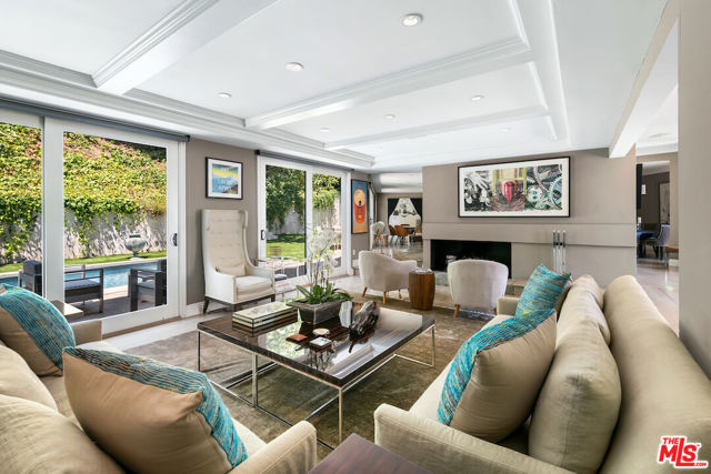 2229 San Ysidro Drive Beverly Hills, California Transitional contemporary on a corner lot including a large flat grassy yard with pool. Open floor plan, drenched with natural light, ideal for entertaining. Expansive formal living room and separate dining room. Updated kitchen with top-of-the-line appliances. Gorgeous primary suite includes a fireplace and two large walk-in closets. Two car garage with plenty of storage space. This property is completely gated and private. Don't miss this rare gem!