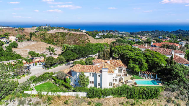 Welcome to 6015 Galahad Drive, a stunning gated Tuscan-inspired estate offering a rare combination of privacy, natural beauty, and convenient proximity to all that Malibu has to offer.  Upon entering, you are greeted with high ceilings, stunning limestone flooring, and a light and bright interior which helps provide a relaxing environment to enjoy the home's spacious and open floor plan.  An elegantly appointed library, formal living, and dining room illustrate just part of this beautiful estate's unparalleled design.  The wide plank oak flooring seamlessly unites the welcoming family room, chef's kitchen and intimate dining nook which offers both garden and ocean views.  French doors lead out to a resort-like backyard with multiple entertainment and sitting areas, picturesque views, and showcases the recently renovated pool and spa. A lush side yard serves as a versatile oasis for a range of activities.  Two en-suite bedrooms, laundry room and a powder bath complete the downstairs living area.  A striking custom wrought iron spiral staircase situated in the eye-catching rotunda leads you to three upper-level bedrooms.  Embrace the sunrise of a new day in the exquisite primary suite with a private ocean view balcony.  The primary bath features an oversized soaking tub, large shower and two walk-in closets.  Two additional generously sized en-suite bedrooms provide a serene and relaxed environment, as they look out upon the surrounding mountain views.  Spanning 5,665 square feet, this captivating residence features 5 bedrooms and 5.5 bathrooms, 4 fireplaces, a 3-car garage, ocean and mountain views and tranquil garden areas including a pool and spa to offer the most quintessential Malibu living.