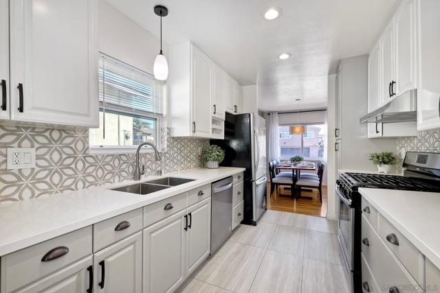 Beautifully Updated Kitchen with Quartz Countertops, Custom Backsplash and all Stainless Appliances! Enjoy your Window above the Sink!